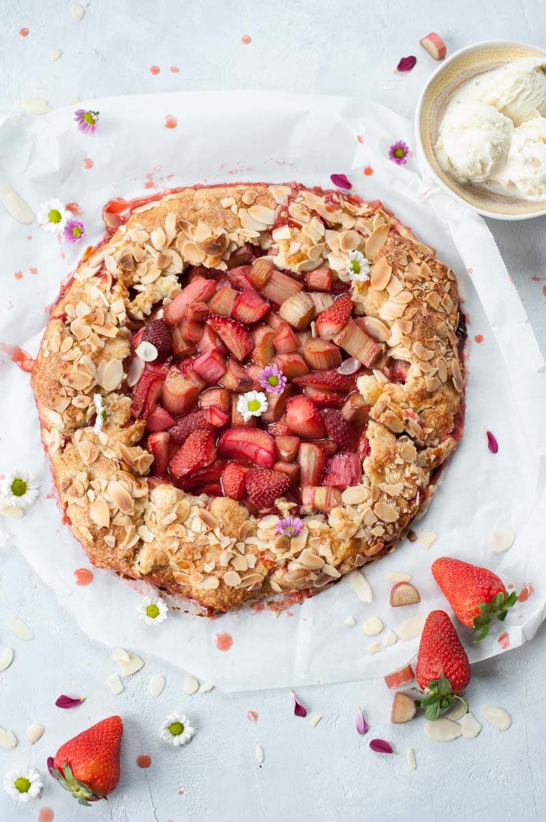 Strawberry rhubarb galette on a baking paper.