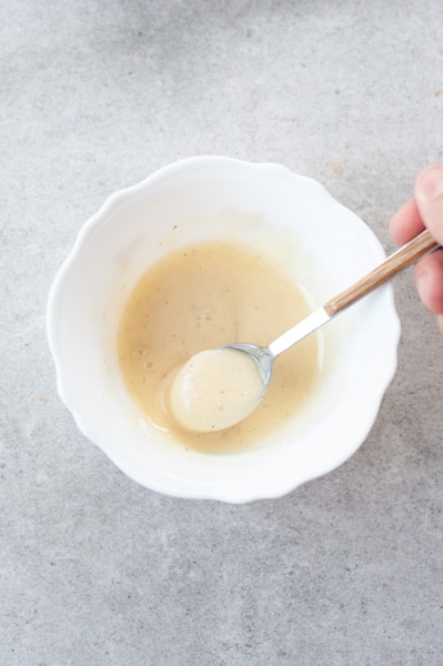 passion fruit glaze in a small white bowl