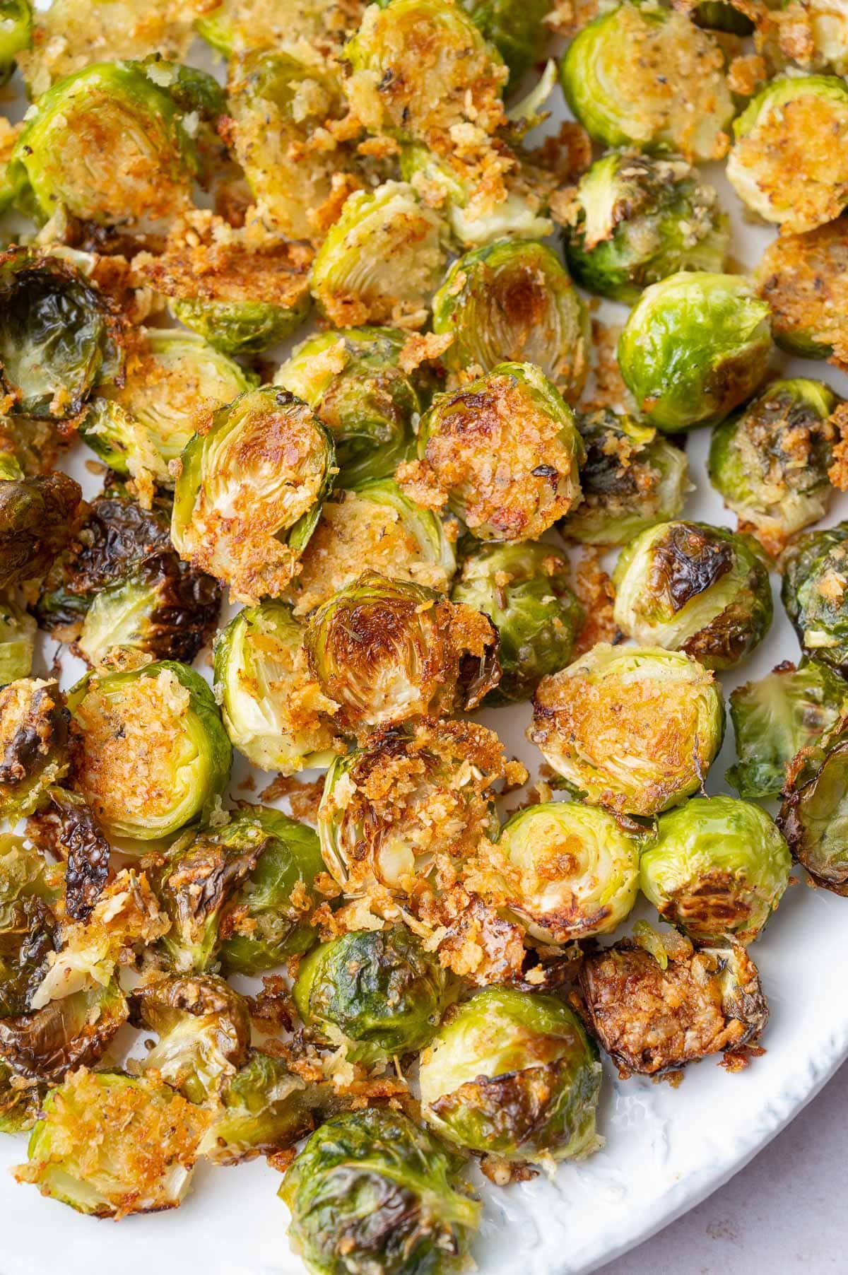 Parmesan roasted brussel sprouts on a white plate.