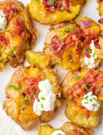 Loaded Smashed Potatoes on a white plate.