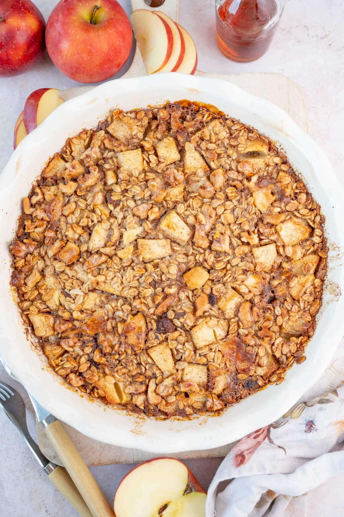 Baked apple oatmeal in a white baking dish.