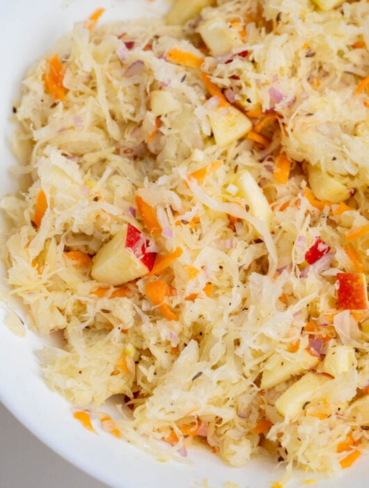 Sauerkraut salad in a white bowl.