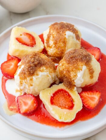 Polish strawberry dumplings knedle on a white plate.