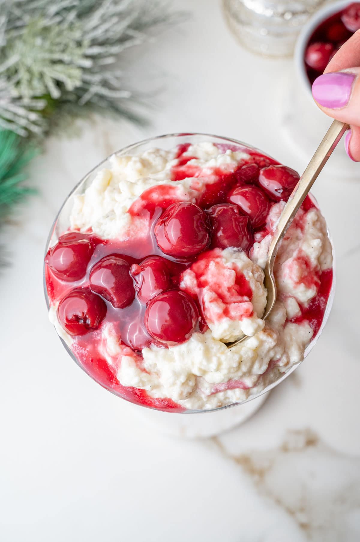 An overhead photo of Risalamande with cherry sauce in a cocktail glass.