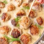 Polish meatballs in dill sauce in a frying pan.