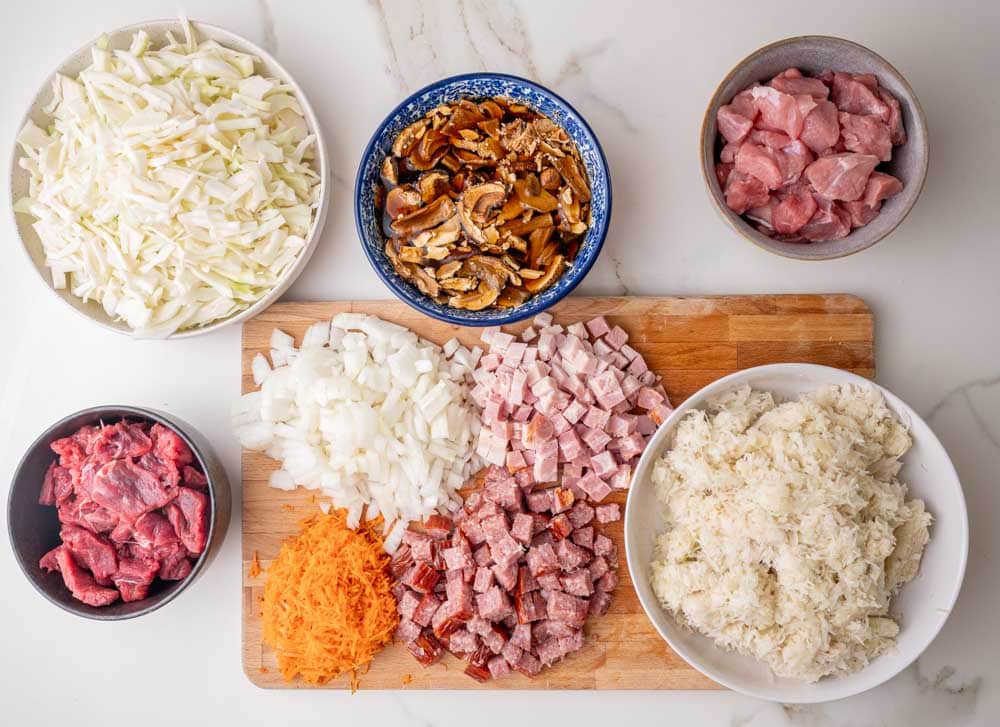 Chopped/prepared ingredients for bigos on a counter.